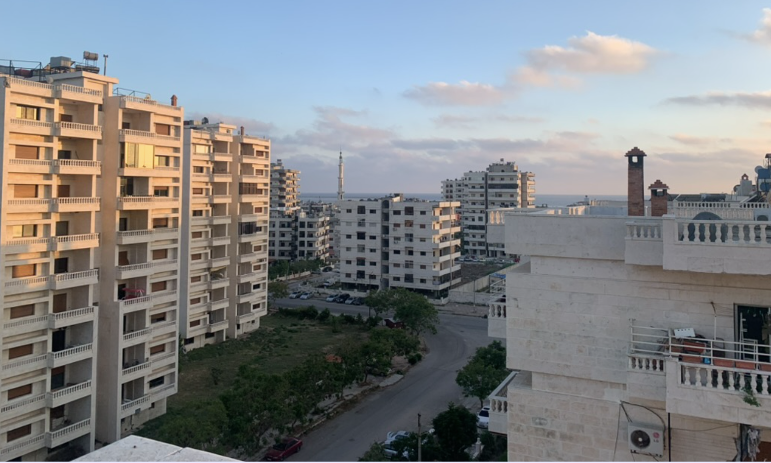 Syrian cityscape with apartment buildings under blue sky